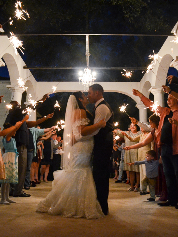Everlasting Elopements couple looking at each other under guests holding sparklers at The Gardens At West Green