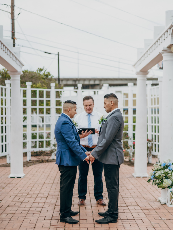 Everlasting Elopements couple holding hands standing in front of garden during ceremony at Lytton Memorial Rose Garden