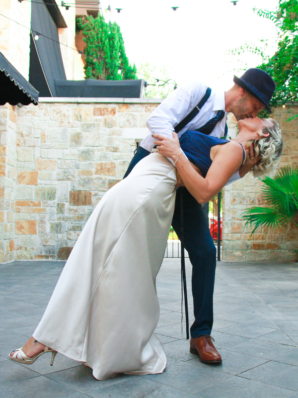 Maggiano's San Antonio Everlasting Elopements couple kissing in front of stone wall at Maggiano's San Antonio