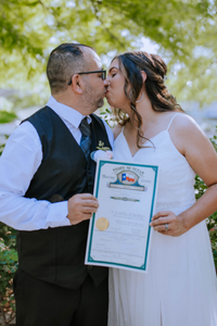 Everlasting Elopements couple with their signed marriage license on the San Antonio Riverwalk Everlasting Elopements couple kissing and holding up their signed marriage license on the San Antonio Riverwalk