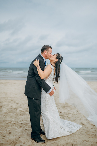 Everlasting Elopements couple on beach kissing after marriage